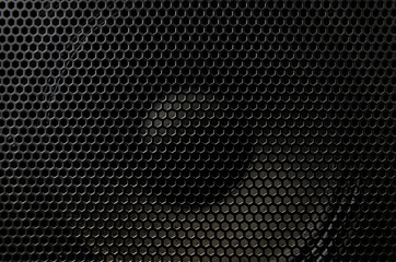Fragment of the speaker with a metal perforated grille