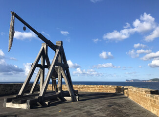 catapult on seafront bastions at alghero, sardinia, italy