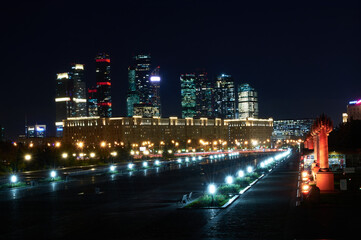 Naklejka premium Space landscape of a night city, sparkling with lights and skyscrapers in the background. Russian city landscape.