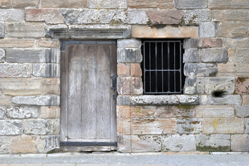 Close Up of Old Wooden Door & Barred Window in Ancient Ruined Building 