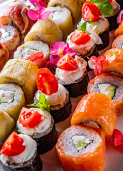 set of sushi roll with salmon, avocado, cream cheese, cucumber, rice, caviar, eel, tuna in plate