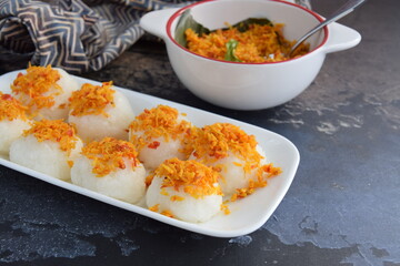 Ketan Serundeng. Indonesian cuisine. Savory steamed cake of glutinous rice with coconut milk, topped with spicy roasted desiccated coconut