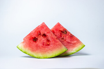 Watermelon on a white background. Cut off a slice of watermelon. Red ripe watermelon