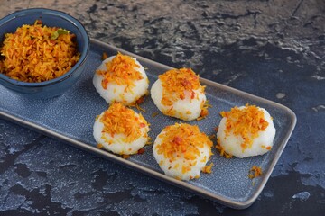 Ketan Serundeng. Indonesian cuisine. Savory steamed cake of glutinous rice with coconut milk, topped with spicy roasted desiccated coconut