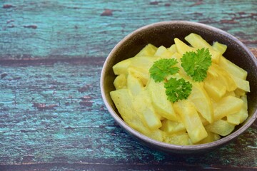 Steamed Kohlrabi (German turnip) with coconut milk curry sauce garnish with parsley