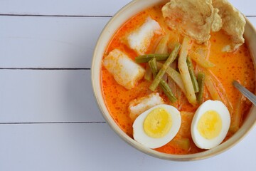 Lontong Sayur, Indonesian cuisine. Compressed rice cake or lontong with vegetables (chayote and yard long beans) cooked in coconut milk and spices. Served with boiled egg and emping cracker