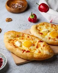 Georgian pastry khachapuri with cheese and egg, close-up