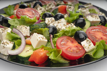Delicious greek salad on a platter macro frame, close up
