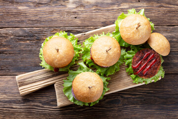 Cooking delicious burgers with grilled cutlet, top view