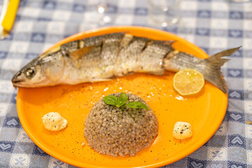 Oven cooked mullet with caramelized lemon served with buckwheat bowl topped with basil. Simple and healthy home dinner  
