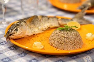 Oven cooked mullet with caramelized lemon served with buckwheat bowl topped with basil. Simple and healthy home dinner  
