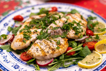 Grilled swordfish over bed of 
rocket salad cherry tomatoes and  radish topped with parsley extra virgin Italian olive oil lemon juice.
Healthy dinner 