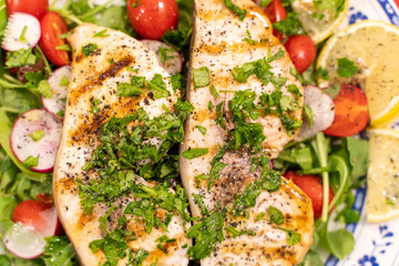 Grilled swordfish over bed of 
rocket salad cherry tomatoes and  radish topped with parsley extra virgin Italian olive oil lemon juice.
Healthy dinner 