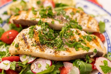Grilled swordfish over bed of 
rocket salad cherry tomatoes and  radish topped with parsley extra virgin Italian olive oil lemon juice.
Healthy dinner 