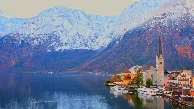 Hallstatt, a charming village on the Hallstattersee lake and a famous tourist attraction, with beautiful mountains surrounding it, in Salzkammergut region, Austria, in winter sunny day.