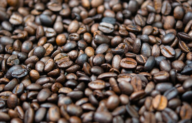 Dark roasted coffee beans close-up. Coffee background