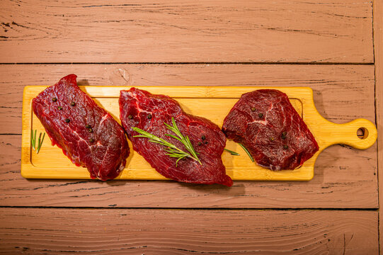 Three Raw Steaks Of Marbled Rib Eye Beef, Filet Mignon