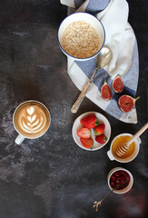 cereal and various delicious ingredients for breakfast on a wood background, flat lay concept. English breakfast