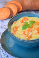 Sweet potato risotto with basil leaf in a bowl