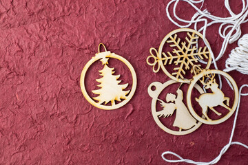 Wooden Christmas decorations on a red background. Festive background with place for text.