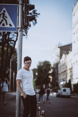 Fototapeta premium Guy stand on the city street, look camera and around