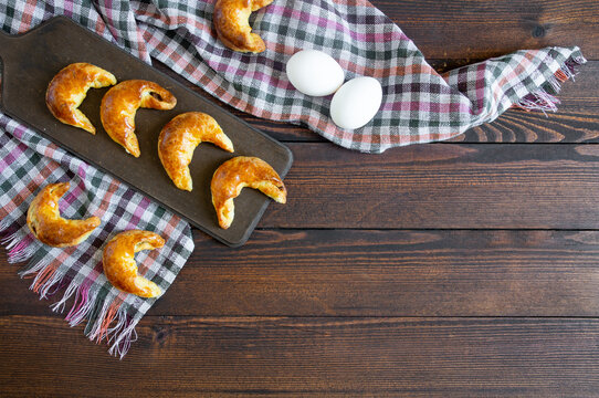 Homemade salty moon bun on wooden table, croissant, cookies potato and meat, turkish pastry, ay coregi