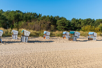 Fototapeta na wymiar wicker beach chairs on a beach at the baltic sea in usedom, germany