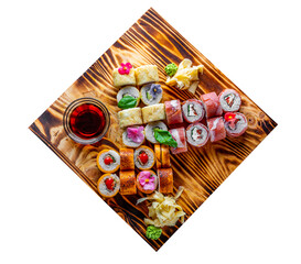 set of sushi roll with salmon, avocado, cream cheese, cucumber, rice, caviar, eel, tuna in wooden plate isolated on white background