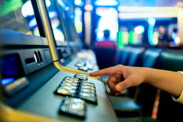 close up player hand push start slot machine button wheel to win the gambling game casino...