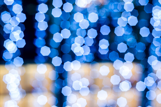Bokeh, blue garlands in focus, Christmas lights in the shape of a hexagon, Christmas.
