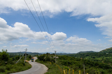 Single one way road of hill rural area, this road go through middle of two mountains its loom very...