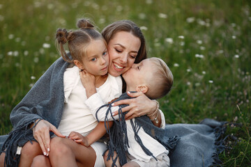 Family spends time on vacation in the village. Boy and girl playing in nature. People walk in the fresh air.