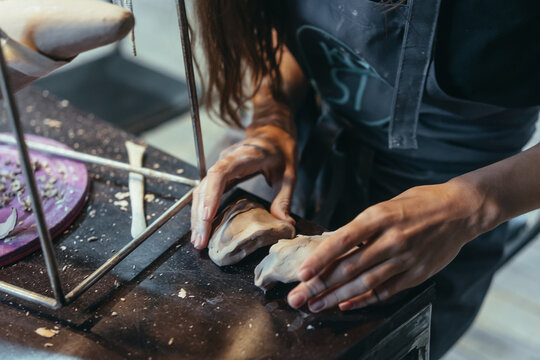 Portrait of young woman enjoying favorite job in workshop. © teksomolika