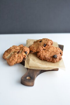 Gray jar with homemade oatmeat cookies on wooden board. Copy space.