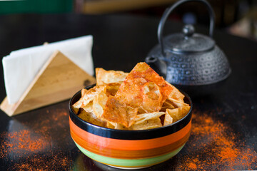 nachos chips and beer snack in the colorful bowl on the table in restaurant