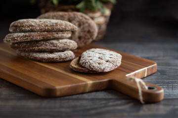 Rye bread on a wooden table. A crust of bread. Close-up. Cutting board. Diet.