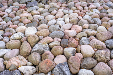 Multicolored round balls stones cobblestones background. Many colorful stones boulders are piled up. Garden park landscape design. Alpine hill.
