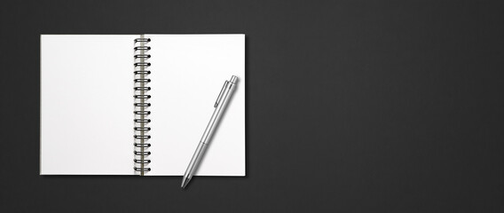 Blank open spiral notebook and pen isolated on black banner