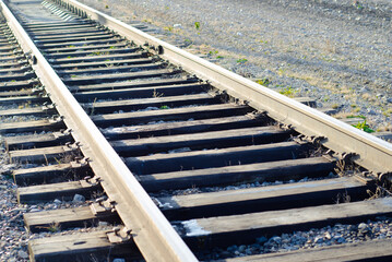 Railway tracks close-up. Rails and sleepers. Transport route. Romance of roads.