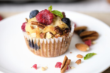 mixed berry low carb Keto Diet muffin with almond and nut. set on cafe table.