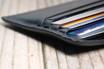 close up of credit cards in a wallet on wooden background 