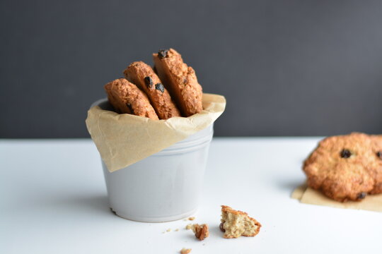 Gray jar with homemade oatmeat cookies on gray background. Copy space.