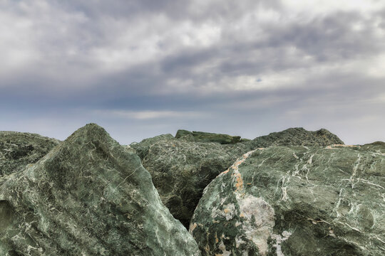 Big heavy Duty Stones. Copy Space. Isolated.Large stones protecting the harbor walls. Sky in the background. Stock Image.