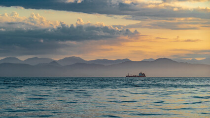 Kamchatka. Sunset on Avacha Bay with a ship on the horizon. Petropavlovsk Kamchatsky.