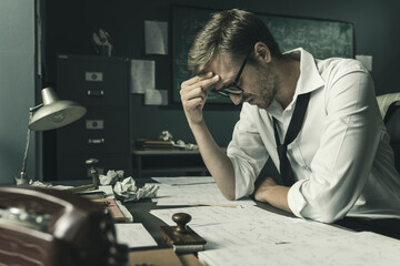 Brilliant mathematician sitting at desk and studying math formulas
