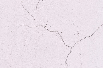 Obraz premium Light textured plaster as a background.Cracks in the wall