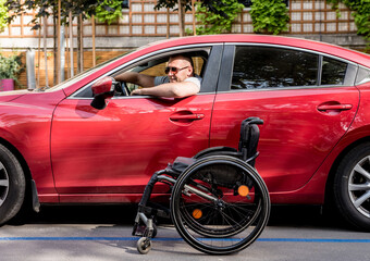 Young handicapped man on driver's seat of his car