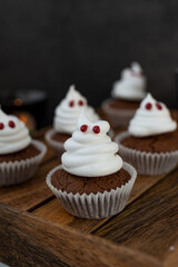 Halloween ghost cupcakes , homemade sweet chocolate muffins with meringue ghost