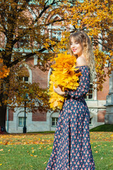 Beautiful girl with autumn leaves. October photos of autumn.