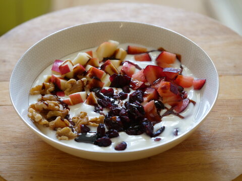 Bowl of yogurt with fresh fruits nuts and silan